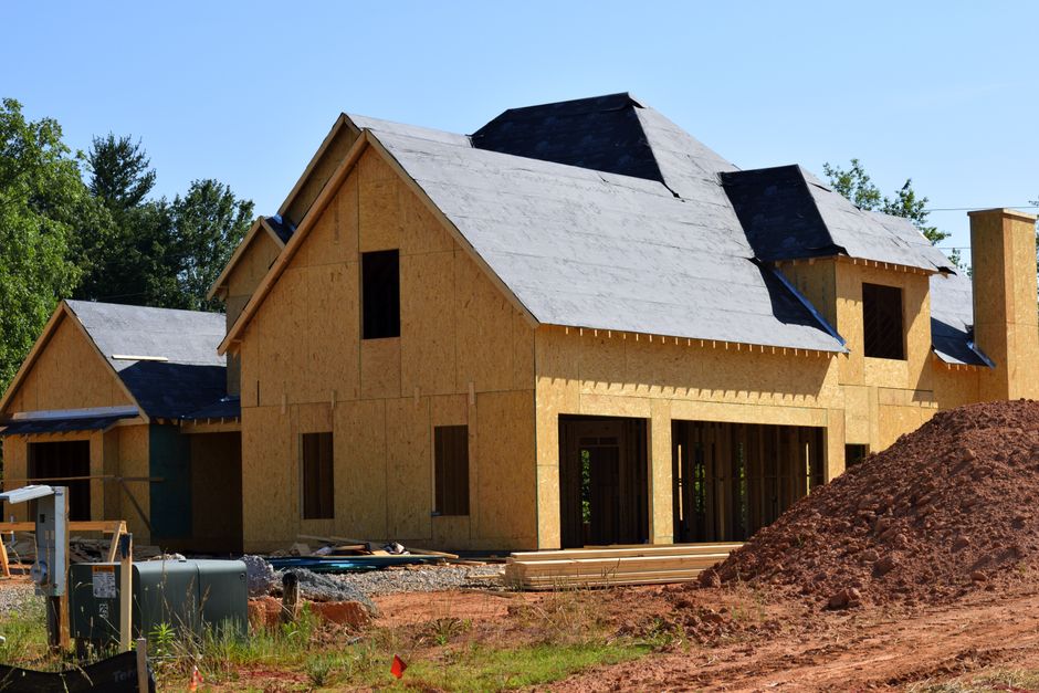 New home under construction with framing exposed